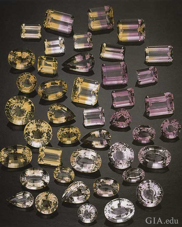 Arrangement of faceted citrine, amethyst, and ametrine gems in varying shades of yellow and purple from the Anahí mine crystals exhibit the November birthstone. Arrangement of faceted citrine, amethyst, and ametrine gems in varying shades of yellow and purple from the Anahí mine crystals exhibit the November birthstone.