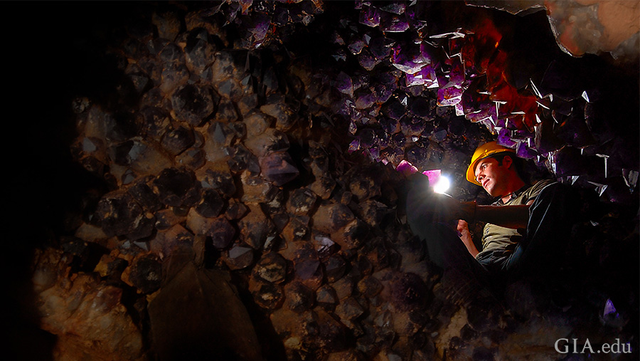 A miner shines a light to reveal thousands of purple amethyst and yellow citrine crystals lining the walls of the Anahí mine in Bolivia, where the November birthstone can be found. A miner shines a light to reveal thousands of purple amethyst and yellow citrine crystals lining the walls of the Anahí mine in Bolivia, where the November birthstone can be found.