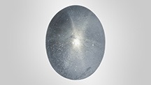 Figure 1. A 13.37 ct grayish blue aquamarine displaying asterism. Photo by Towfiq Ahmed. Figure 1. A 13.37 ct grayish blue aquamarine displaying asterism. Photo by Towfiq Ahmed.