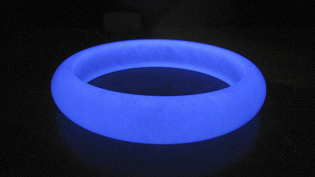 Polymer-impregnated aventurine quartz bangle under UV light