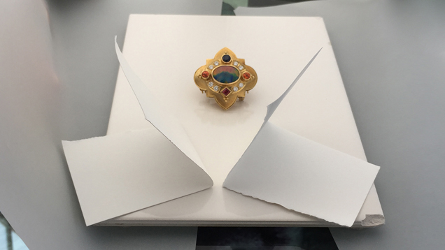 Image showing white cards bouncing light towards a jeweled brooch.