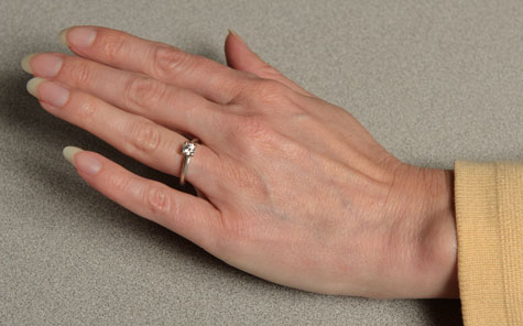 Female hand featuring a properly fitted platinum solitaire