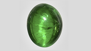 Cat's-eye demantoid with well-aligned horsetail inclusions.