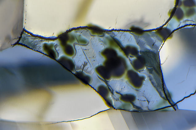 Diamond surface with dark green radiation stains.