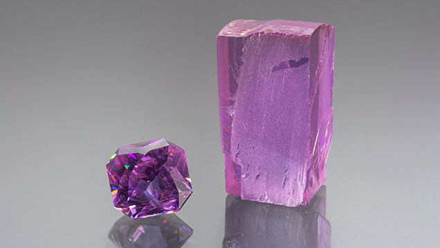 Figure 1. Faceted and rough synthetic wakefieldite in LED lighting with 6400K color temperature. The faceted stone is 5.04 ct. Photo by Adriana Gudino; courtesy of Arya Akhavan.