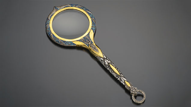 Figure 2. Silver magnifying glass with 24K gold embellishments, inlay, carvings, and diamonds. Photo by Robert Weldon; courtesy of Zeki Karaca.