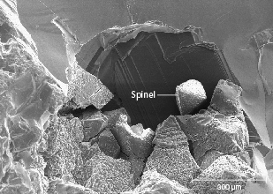 Figure 27. SEM image of the surface of a sapphire from Missouri River showing the spinel coating sometimes seen in stones from this deposit but never in sapphire from Rock Creek or Dry Cottonwood Creek. Image by Richard Berg.