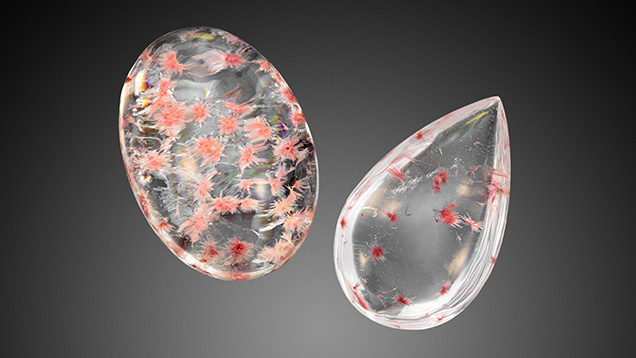 Figure 2. Weighing 11.18 ct (left) and 5.47 ct (right), these two rock crystal quartz cabochons play host to very unusual pink crystal sprays. Photo by Adriana Robinson.