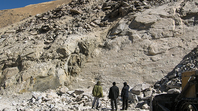 An outcrop of white marble and dumps at the corundum deposit in Snezhnoe, Tajikistan.