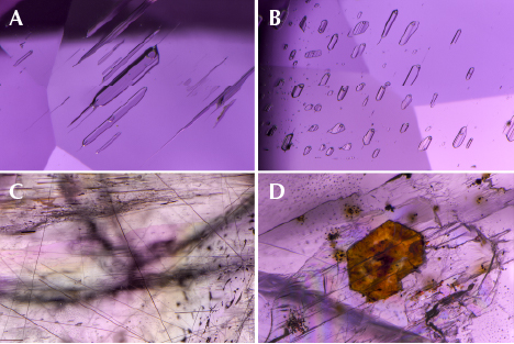 Fluid inclusions, rutile needles, and a crystal in purplish pink diaspore.