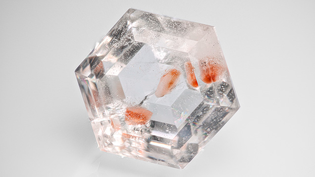 Figure 1. A 30.80 ct faceted quartz containing pinkish orange inclusions. Photo by Hongtao Shen; courtesy of Jinrui Dong.