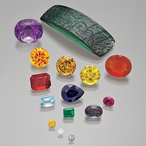 Figure 1. Synthetic alexandrite, amethyst, beryl, corundum, diamond, and fire opal. The three smallest stones are synthetic diamonds ranging from 0.06 to 0.14 ct. Photo by Robert Weldon.