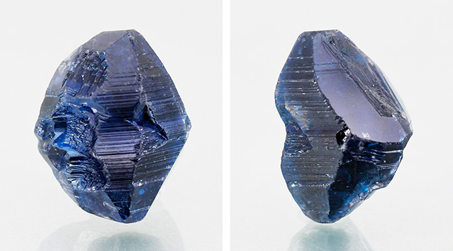 Figure 1. This unusually large 64.70 ct rough specimen displaying a bipyramidal crystal habit and stepped striations was identified as a flux-grown synthetic sapphire. Note the large rhombohedral face in the image on right. Photos by Gagan Choudhary.