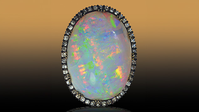 Figure 1. A silver brooch containing a large Slovak opal (77 ct, 34.5 × 25 × 13 mm) and 48 diamonds. The opal was initially purchased for Louis XVIII’s personal collection. In 1824, it adorned the clasp of Charles X’s coronation mantle, and around 1853 it was remounted onto this brooch for Empress Eugénie, which has been preserved. Photo by Peter Semrád; courtesy of the National Museum of Natural History in Paris (inventory no. MNHN 87.44).