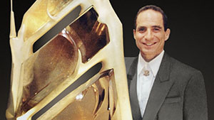 Glenn Lehrer next to the rutilated quartz carving “Bahia,” created with Lawrence Stoller.