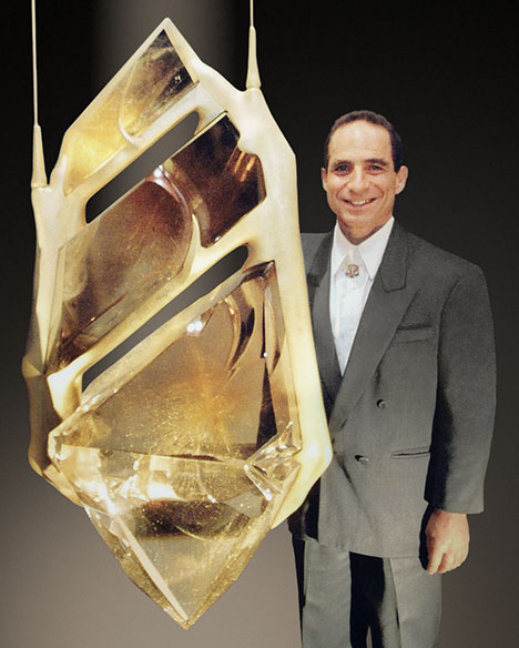 Glenn Lehrer next to the rutilated quartz carving “Bahia,” created with Lawrence Stoller.