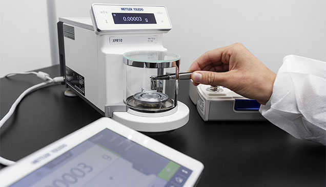 Figure 5. A GIA metrologist uses a calibrated standard to verify instrument performance. Photo by Kevin Schumacher.