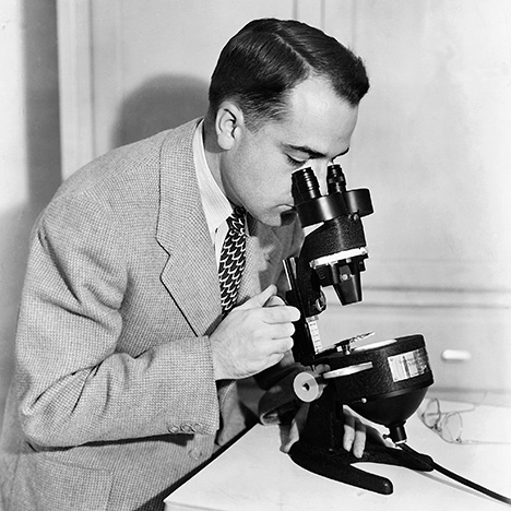 Figure 4. Richard Liddicoat using a stereomicroscope (the GIA Diamondscope) with darkfield illumination. Introduced in 1938, it provided improved viewing of inclusions and clarity features in gemstones.